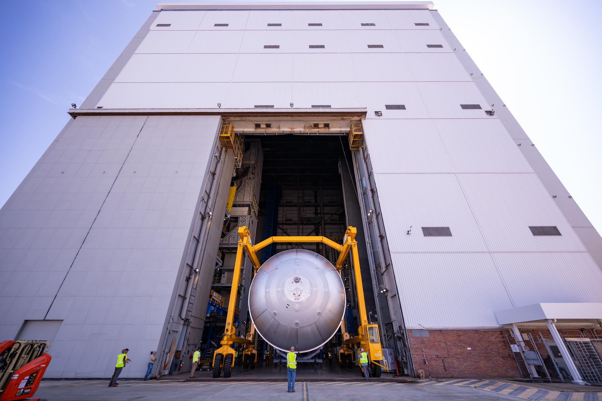 Teams at NASA’s Michoud Assembly Facility in New Orleans move a liquid oxygen tank from the main rocket factory into the adjacent vertical assembly building. The liquid oxygen tank, which will form part of the SLS (Space Launch System) rocket for NASA’s Artemis IV mission to the Moon, is rotated from a horizontal to a vertical configuration and loaded into the high bay’s hydrostatic proof testing cell. This non-destructive evaluation method tests the structural integrity of the tank’s welds by filling the tank with water, simulating the propellant used during launch. The propellant tank will hold more than 196,000 gallons of super-cooled liquid oxygen at launch and is one of five major elements that make up the 212-foot-tall SLS rocket stage. The core stage, along with its four RS-25 engines at its base, produces more than two million pounds of thrust to help launch NASA’s Orion spacecraft, astronauts, and supplies beyond Earth’s orbit and to the lunar surface for Artemis.